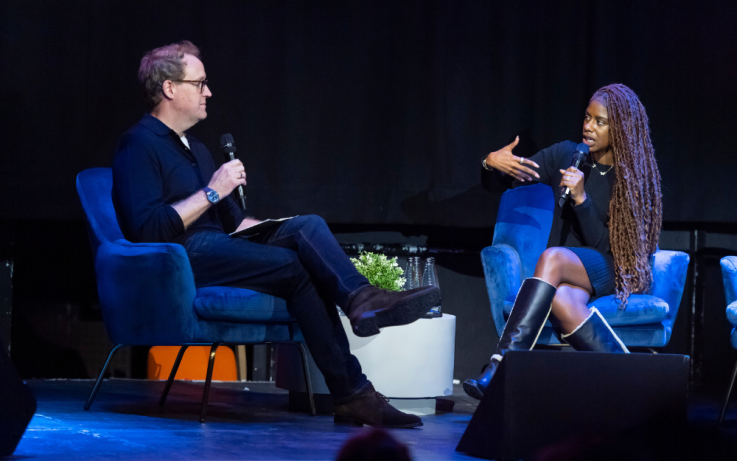 Two people on stage talking at an IAB UK event